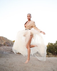 a woman wearing a tulle skirt and a blazer