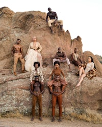 a group of people posing on a rock